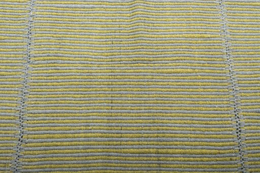 Backside of handmade New Modern Design rug showing knot structure and weave density
