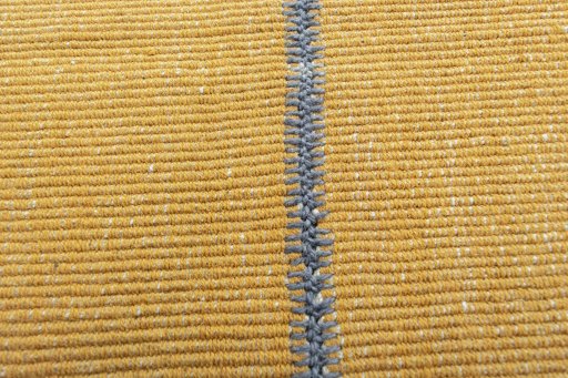Backside of handmade New Modern Design rug showing knot structure and weave density