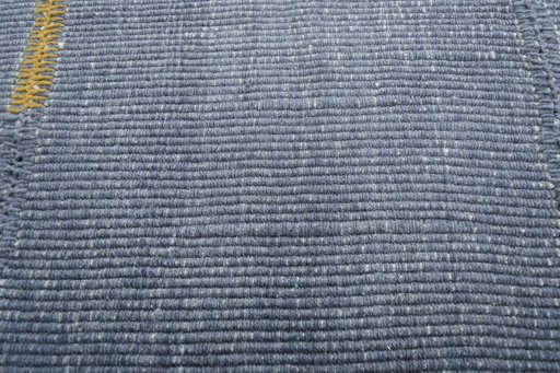Backside of handmade New Modern Design rug showing knot structure and weave density