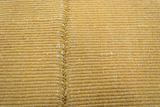 Backside of handmade New Modern Design rug showing knot structure and weave density