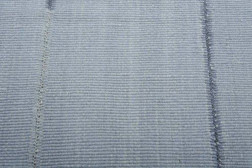 Backside of handmade New Modern Design rug showing knot structure and weave density