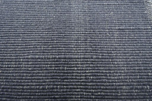 Backside of handmade New Modern Design rug showing knot structure and weave density