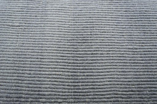 Backside of handmade New Modern Design rug showing knot structure and weave density