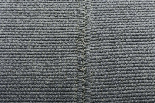 Backside of handmade New Modern Design rug showing knot structure and weave density