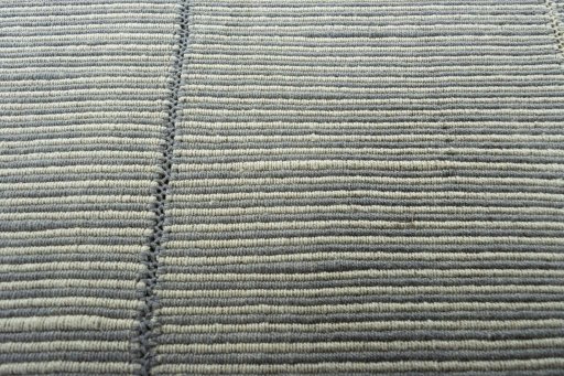Backside of handmade New Modern Design rug showing knot structure and weave density