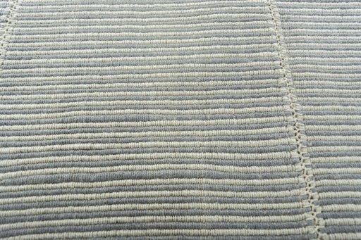 Backside of handmade New Modern Design rug showing knot structure and weave density