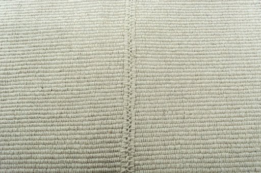 Backside of handmade New Modern Design rug showing knot structure and weave density