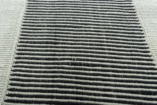 Backside of handmade New Modern Design rug showing knot structure and weave density