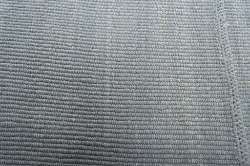 Backside of handmade New Modern Design rug showing knot structure and weave density