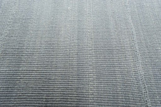Backside of handmade New Modern Design rug showing knot structure and weave density