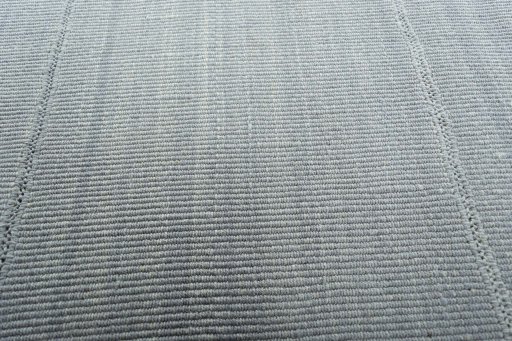Backside of handmade New Modern Design rug showing knot structure and weave density