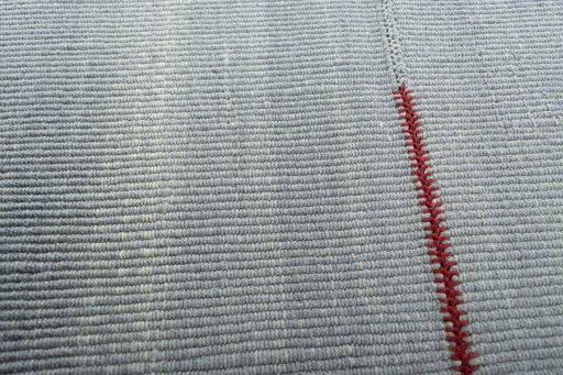 Backside of handmade New Modern Design rug showing knot structure and weave density