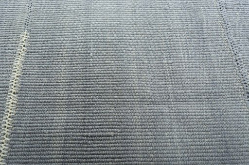 Backside of handmade New Modern Design rug showing knot structure and weave density