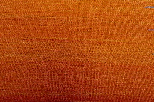 Backside of handmade New Modern Design rug showing knot structure and weave density