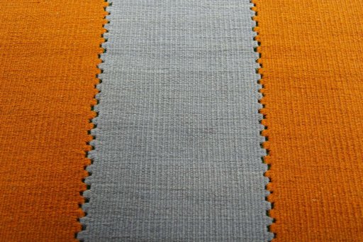 Backside of handmade New Modern Design rug showing knot structure and weave density