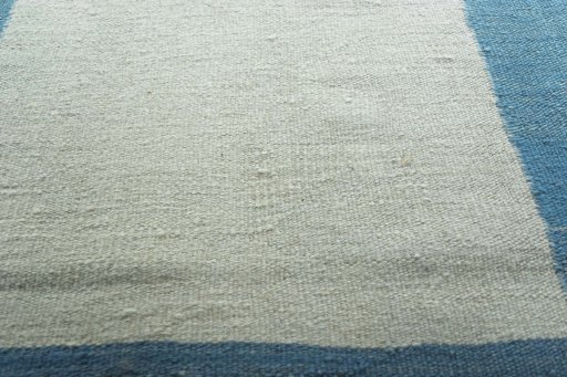 Backside of handmade New Modern Design rug showing knot structure and weave density