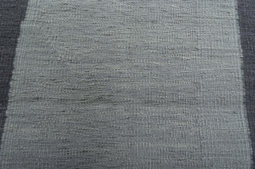 Backside of handmade New Modern Design rug showing knot structure and weave density