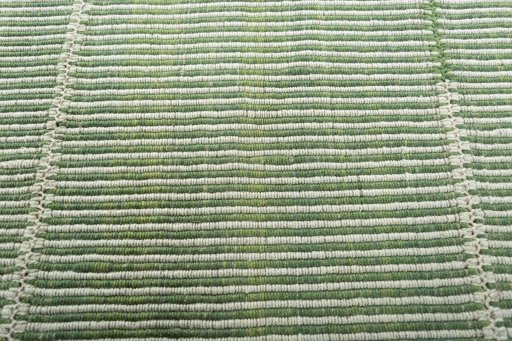 Backside of handmade New Modern Design rug showing knot structure and weave density