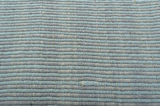 Backside of handmade New Modern Design rug showing knot structure and weave density