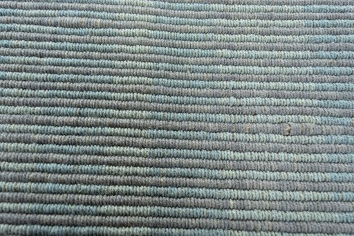 Backside of handmade New Modern Design rug showing knot structure and weave density