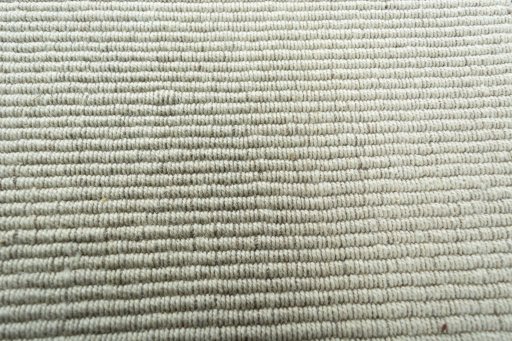 Backside of handmade New Modern Design rug showing knot structure and weave density