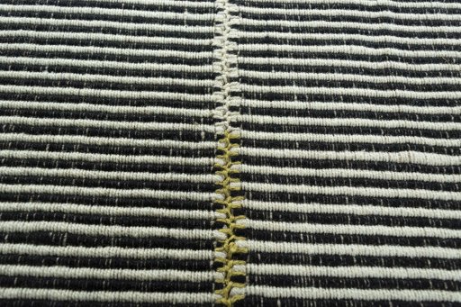 Backside of handmade New Modern Design rug showing knot structure and weave density