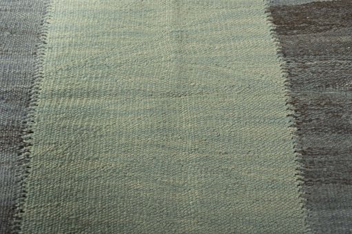 Backside of handmade New Modern Design rug showing knot structure and weave density