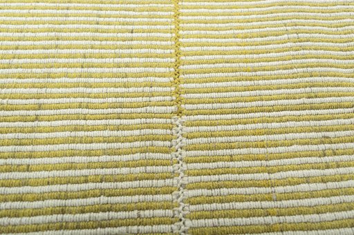 Backside of handmade New Modern Design rug showing knot structure and weave density