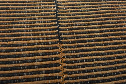 Backside of handmade New Modern Design rug showing knot structure and weave density