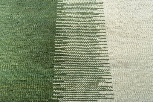 Backside of handmade New Modern Design rug showing knot structure and weave density