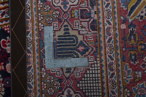 Backside of handmade 2000s Kashan rug showing knot structure and weave density