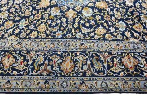 Corner detail of 2000s Kashan rug showing border pattern and Wool pile