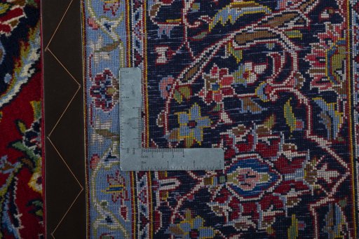 Backside of handmade New Kashan rug showing knot structure and weave density