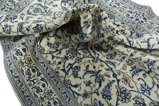 Surface texture of 2000s Nain rug with natural Wool and intricate pattern