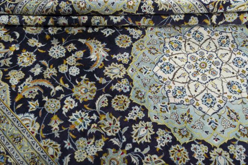 Close-up detail of 2000s Kashan rug from Iran / Persia showing Wool weave