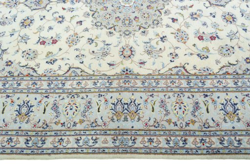 Corner detail of 2000s Kashan rug showing border pattern and Wool pile