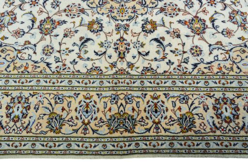 Corner detail of 2000s Kashan rug showing border pattern and Wool pile