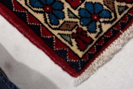 Backside of handmade New Abadeh rug showing knot structure and weave density