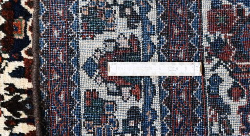 Surface texture of 1950s Abadeh rug with natural Wool and intricate pattern