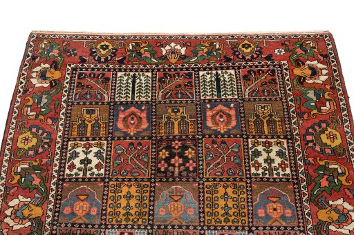 Surface texture of 1920s Bakhtiar rug with natural Wool and intricate pattern