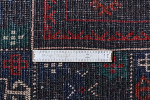 Corner detail of 2000s Baloch rug showing border pattern and Wool pile