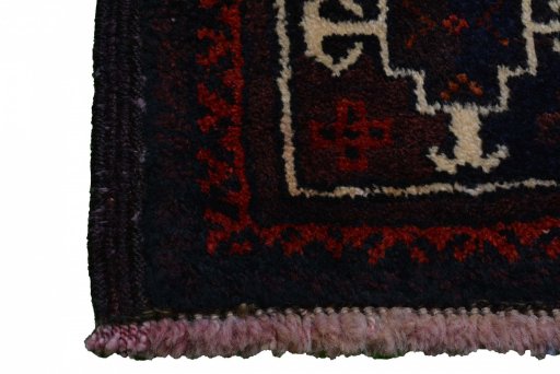 Surface texture of 2000s Baloch rug with natural Wool and intricate pattern