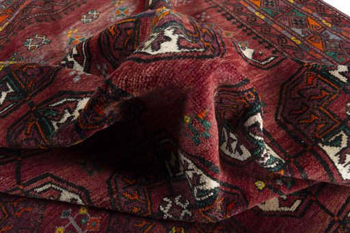 Corner detail of 2000s Baloch rug showing border pattern and Wool pile