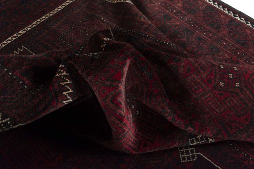 Corner detail of 2000s Baloch rug showing border pattern and Wool pile