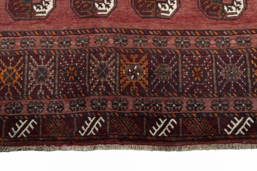 Surface texture of 2000s Baloch rug with natural Wool and intricate pattern