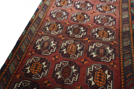 Backside of handmade 2000s Baloch rug showing knot structure and weave density