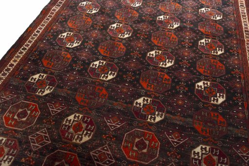 Backside of handmade 2000s Baloch rug showing knot structure and weave density