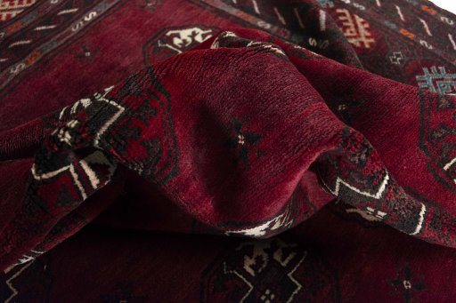 Corner detail of 2000s Baloch rug showing border pattern and Wool pile