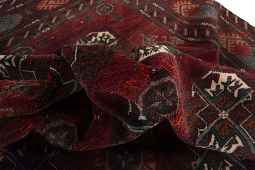 Corner detail of 2000s Baloch rug showing border pattern and Wool pile