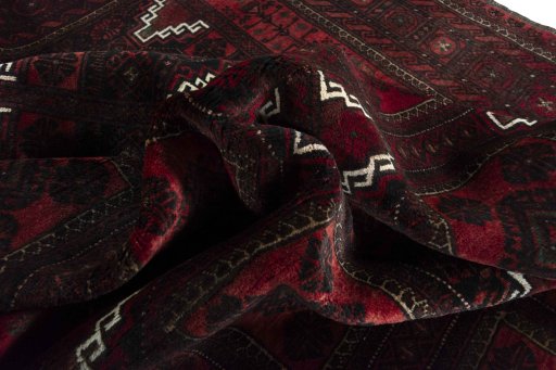 Corner detail of 2000s Baloch rug showing border pattern and Wool pile